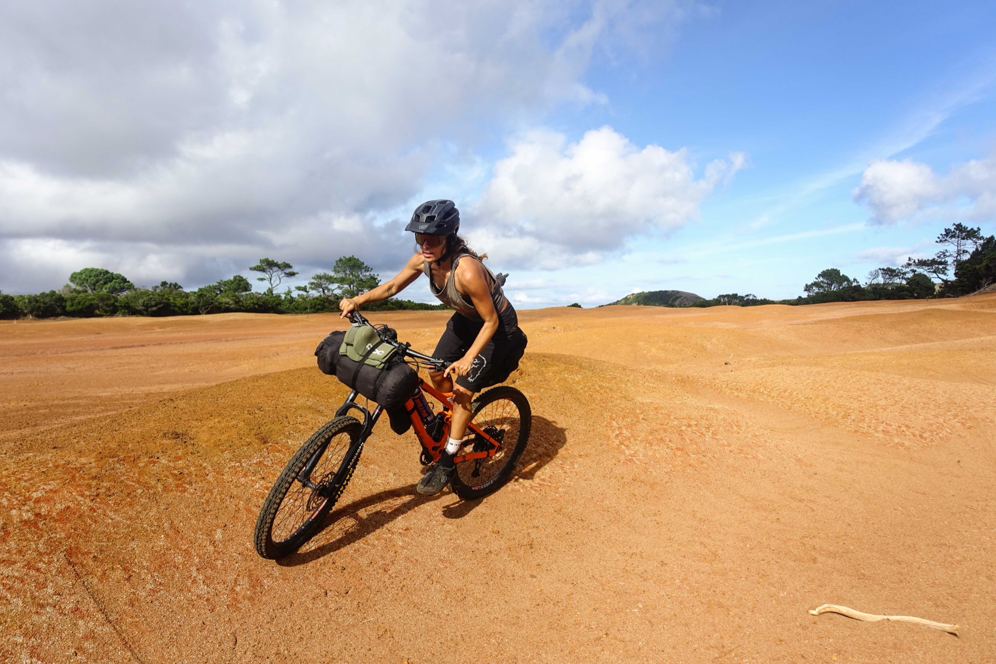 Juliana riding across the red volcanic sand
